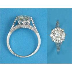An 18k white gold claw-set solitaire diamond ring, the shoulders and gallery set small diamonds,...