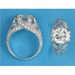 A platinum claw-set solitaire diamond ring, the pierced shoulders and gallery set small diamonds,...