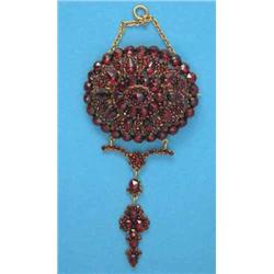 A Victorian garnet set brooch, with attached articulated drop...