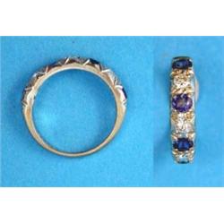 An 18ct white gold half eternity ring, set 4 cornflower blue sapphires and 3 brilliant cut diamon...