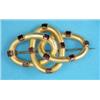 Image 1 : A Victorian bloomed gold brooch, designed as 3 entwined oval links set rectangular garnets...
