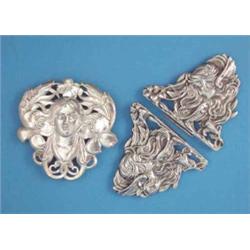 A silver Art Nouveau brooch, designed as a maiden with flowers in her hair, together with a simil...