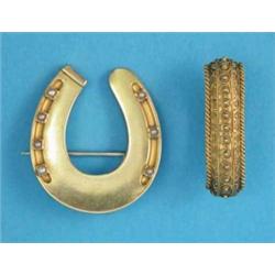 A Victorian gold horseshoe brooch, set seed pearls and a gold stock grip...