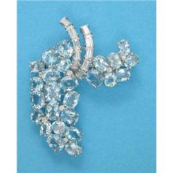 A white gold floral spray brooch, set oval aquamarines and baguette and round cut diamonds...