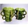 Image 1 : 'No.3', Two green four handled mugs, the tapering cylindrical sides with raised yellow and red roun.