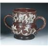 Image 1 : A brown two handled loving mug, the broad thistle shape applied with fruiting vines tinted blue and.