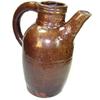 Image 1 : A dark brown spouted jug, the upper terminal of the handle applied to the ring moulded neck with tw.