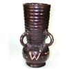 Image 1 : A brown four handled vase, the horizontally ribbed cylindrical neck tapering to the lug handles att.