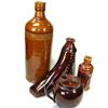 Image 1 : A collection of four treacle glazed wares, to include: a boot shaped flask, 16cm high, a small bott.