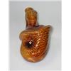 Image 1 : A 19th century treacle glazed mermaid flask, the rather hirsute face and bare breasts above the fis.