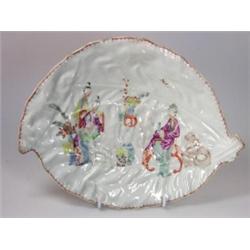An 18th century English leaf dish, possibly Bow, painted with Chinese figures seated by a table sur.