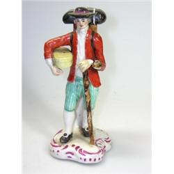An early 19th century European pottery figure, possibly Hannong or Hochst Damm, the traveller with..