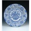 Image 1 : A mid 18th century Delft blue and white charger painted in the kraak style, a bowl containing flowe.