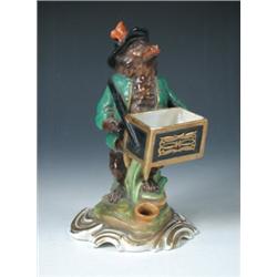 A mid 19th century Paris porcelain bear inkwell figure, the brown bear wearing green Tyrolean jacke.