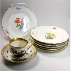 A set of six 20th century Meissen side plates painted with central cut flowers within gilt lined wa.