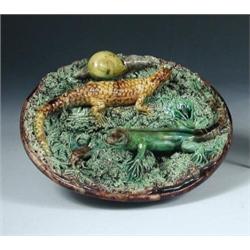 M Mafra, Caldas Portugal, a Palissey ware dish, the interior of the treacle brown bowl filled with..