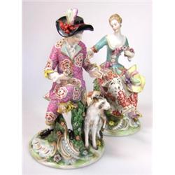 A pair of Samson 'Gold Anchor' figures in their 18th century Sunday best, she seated on a flower en.