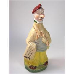 An early 20th century German figural flask modelled as a newspaper vendor wearing yellow trousers a.