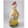 Image 1 : An early 20th century German figural flask modelled as a newspaper vendor wearing yellow trousers a.