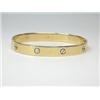 Image 1 : A gold hinge bangle, plain but decorated with screw heads all round, 6.5cm diameter   £350-450...