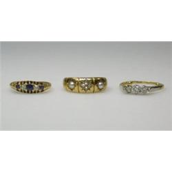 Three rings: an 18ct gold three stone diamond ring, a Victorian 18ct gold pearl and diamond ring an.