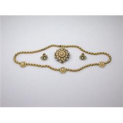 A gold and pearl necklace with three flowerhead inserts together with a matching circular tiered st.