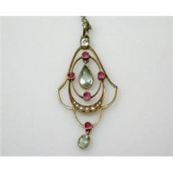 A 15ct gold art nouveau style openwork pendant set with aquamarine, rubies and pearls, 50mm, on a f.