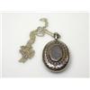 Image 1 : A Victorian silver locket, Birmingham 1892, of oval shape, the front embossed with a laurel wreath..