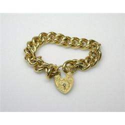 An 18ct gold curb link bracelet, Birmingham 1959 with foliate engraved padlock clasp, 126gm   £1,00.