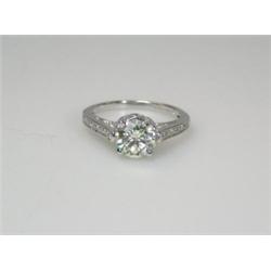 An 18ct white gold and diamond ring set with a single modern brilliant cut stone above diamond shou.