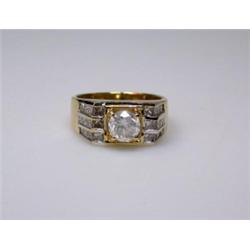 An 18ct gold and diamond ring, the central modern brilliant cut stone above diamond shoulders   £60.