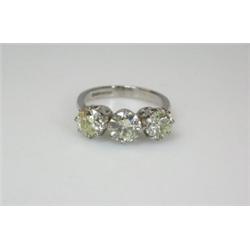 An 18ct gold and diamond ring set with three modern brilliant cut stones   £4,500-5,000...