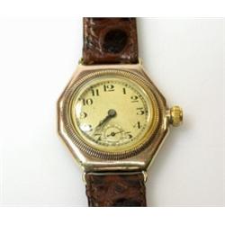A 1920's Gentleman's small size wristwatch by Rolex, with 9ct gold octagonal case, the circular dia.