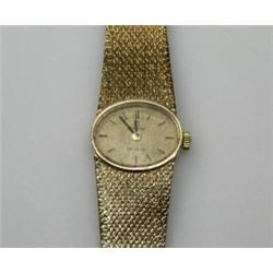 A 9ct gold cased Lady's wristwatch, the oval gold coloured dial with baton numerals signed Omega de.