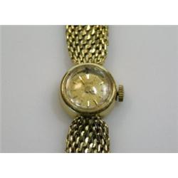 An 18ct gold cased Lady's wristwatch, the circular gold coloured dial with baton numerals, signed P.