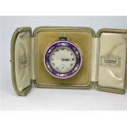 A silver cased travelling bedside clock, import marked for Glasgow 1917, the silvered dial printed..