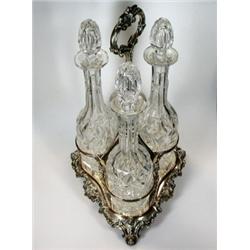 An Old Sheffield plate liquor frame, the shaped triangular base with scrolled edge raised on three..