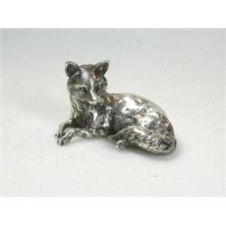A silver figure of a resting fox, maker Ss, London 1975, 5.75cm, 6.75oz   £100-150...