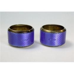 A pair of silver gilt napkin rings, maker JWB, Chester 1924, each decorated in blue bassetaille ena.