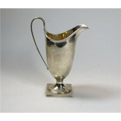A silver helmet cream jug by the Haseler Bros, London 1910, the body plain below a moulded edge, ra.