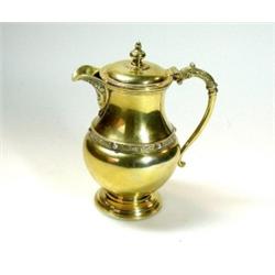 A silver gilt covered cream jug by the Adie Bros, Birmingham 1935, of baluster shape with Celtic de.