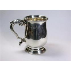 A silver pint beer mug, maker PP Ltd, Sheffield 1952, of plain baluster form with leaf capped scrol.