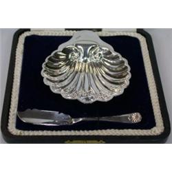 A silver butter shell by James Deakin & Sons, Sheffield 1918, raised on three ball feet, 8.5cm case.