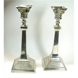 A pair of silver table candlesticks, maker BG & Co, Birmingham 1939, each raised on a square beaded.