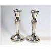 Image 1 : A small pair of silver dressing table candlesticks by W H Manton Ltd, Birmingham 1979, each of plai.