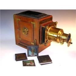 W. Watson & Sons London, a mahogany and brass fitted magic lantern, with a six inch lens, electric..