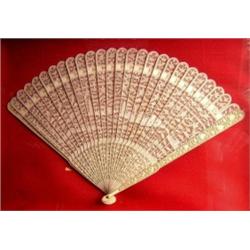 A framed 19th century Chinese ivory brise fan pierced and carved with pagodas, buildings and flower.
