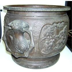 A late 19th century Japanese bronze planter, the sides cast with warrior panels about the shishi an.