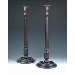 A pair of 19th century stained mahogany candlesticks with gilt brass nozzles and drip pans, the flu.