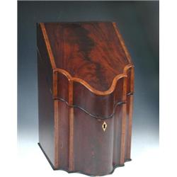 A George III mahogany knife box the shaped front and sloping lid crossbanded in satinwood, the latt.
